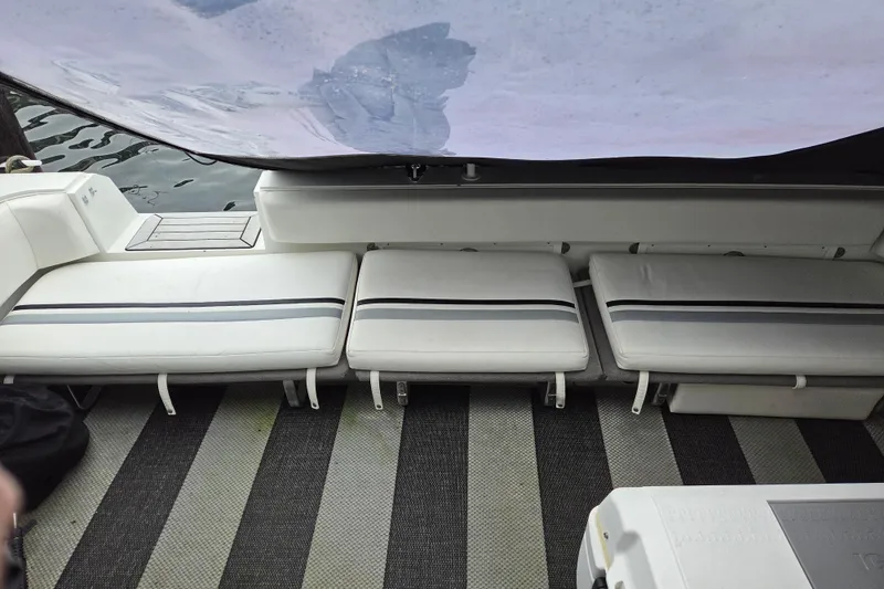 Slide: The Image of 1990 Trojan 10 Meter Express 330 boat interior with striped seating and flooring. - 7