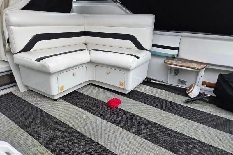 Slide: The Image of Interior of 1990 Trojan 10 Meter Express 330 with white seating and striped flooring. - 8