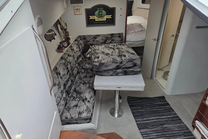 Slide: The Image of Interior of 1990 Trojan 10 Meter Express 330 with patterned seating and compact layout. - 21