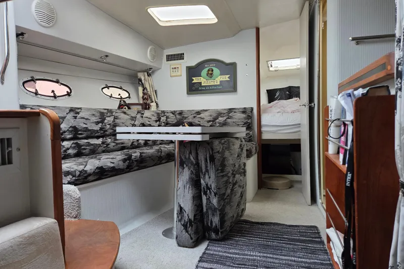 Slide: The Image of Interior of a 1990 Trojan 10 Meter Express 330 boat with cozy seating and decor. - 24