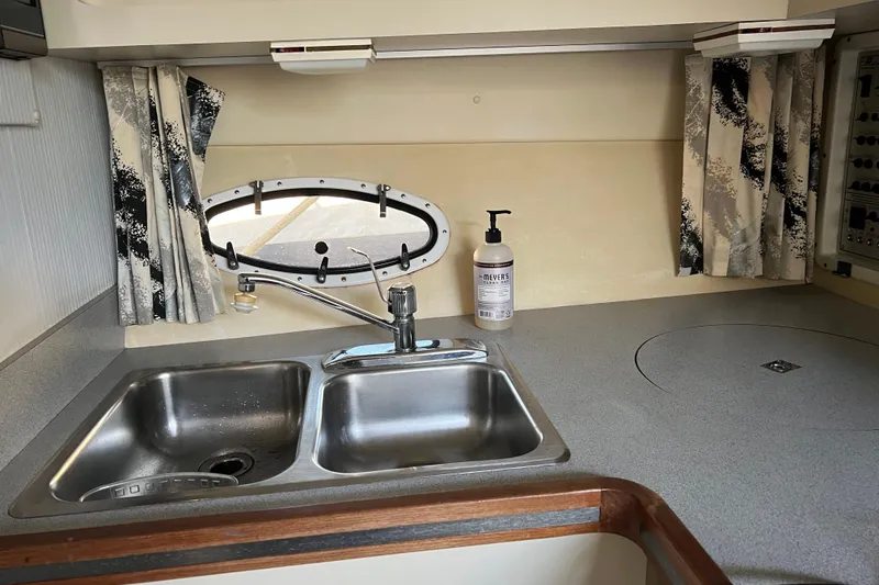 Slide: The Image of 1990 Trojan 10 Meter Express 330 boat kitchen with sink, faucet, and countertop. - 28