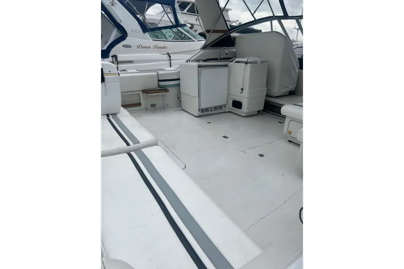 Slide: The Image of 1990 Trojan International 10 Meter Express boat interior with seating and equipment. - 45