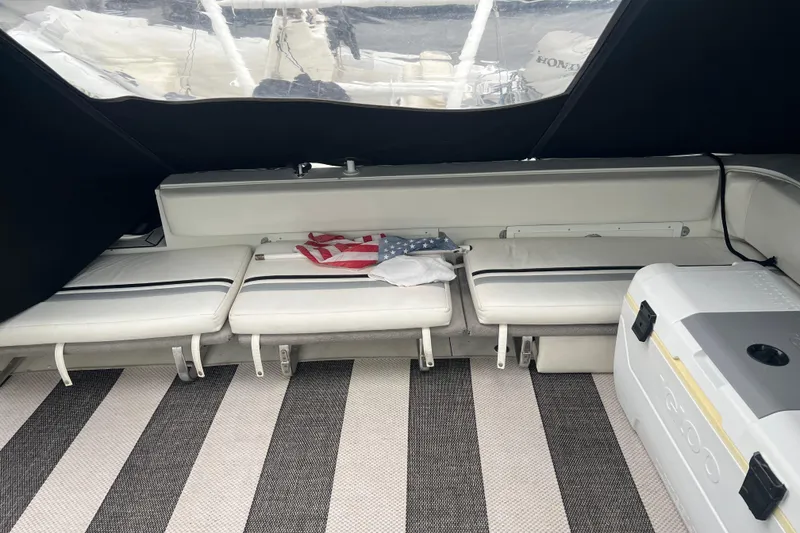 Slide: The Image of Interior of 1990 Trojan 10 Meter Express 330 with seating, cooler, and American flag. - 6