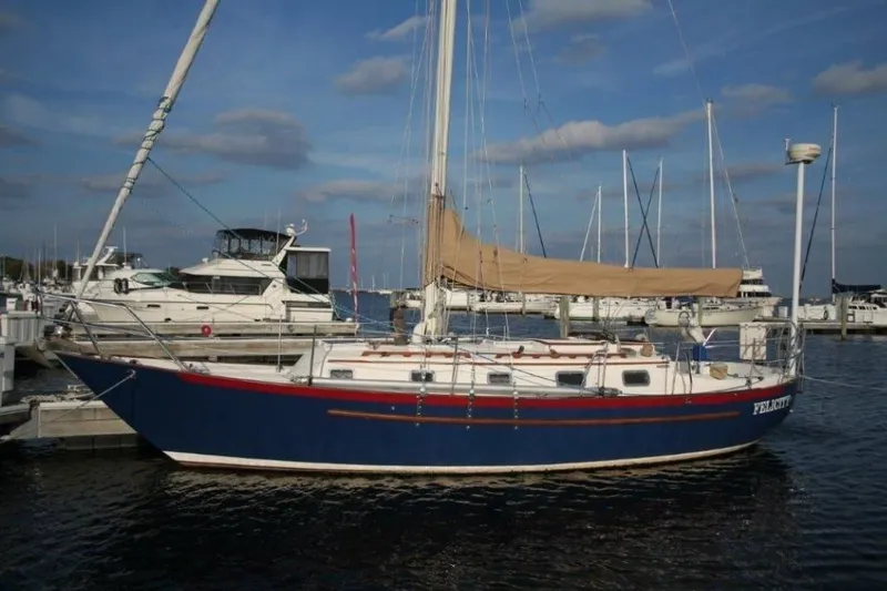 The Image of 1997 Pacific Seacraft 34 sailboat docked at marina under blue sky. - 0