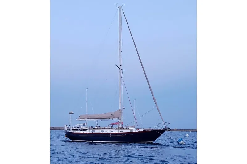 Slide: The Image of 1997 Pacific Seacraft 34 sailboat on calm water at dusk. - 1