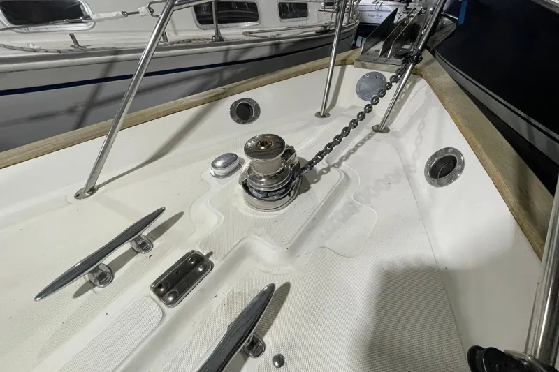 Slide: The Image of Bow of 1997 Pacific Seacraft 34 sailboat with anchor chain and cleats. - 13