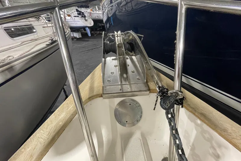 Slide: The Image of Bow of a 1997 Pacific Seacraft 34 sailboat with anchor chain and railing. - 14