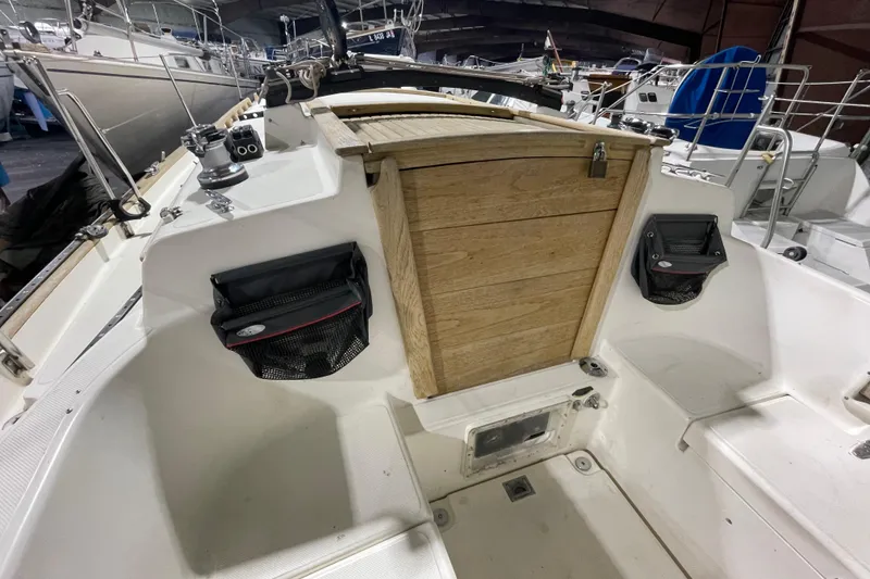 Slide: The Image of Cockpit of 1997 Pacific Seacraft 34 sailboat with wooden hatch and storage pouches. - 17