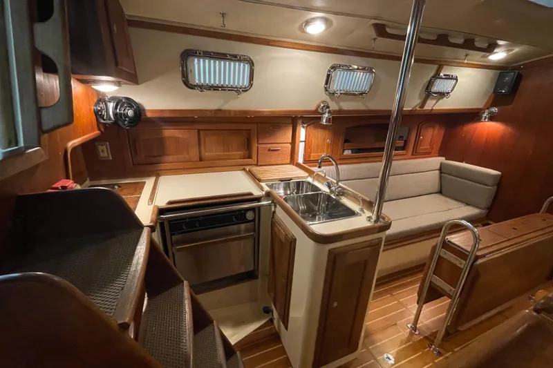 Slide: The Image of Interior of 1997 Pacific Seacraft 34 sailboat with wood finish and compact kitchen. - 19