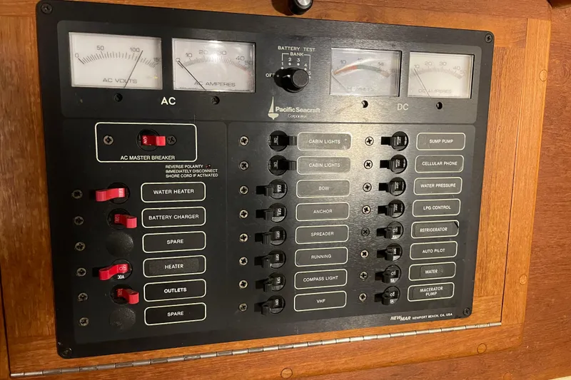 Slide: The Image of Electrical control panel of a 1997 Pacific Seacraft 34 sailboat with AC and DC switches. - 22