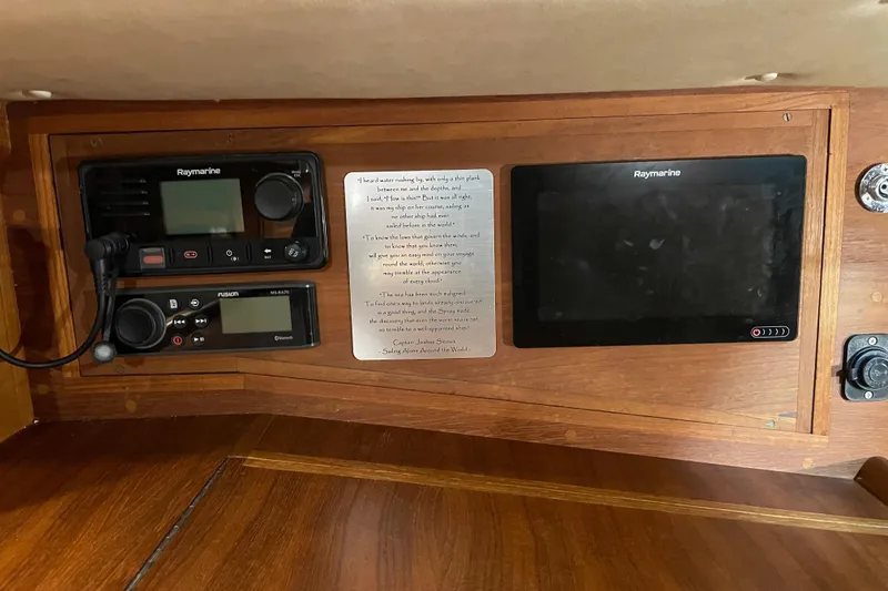 Slide: The Image of Navigation equipment on a 1997 Pacific Seacraft 34 sailboat, featuring Raymarine and Fusion systems. - 23