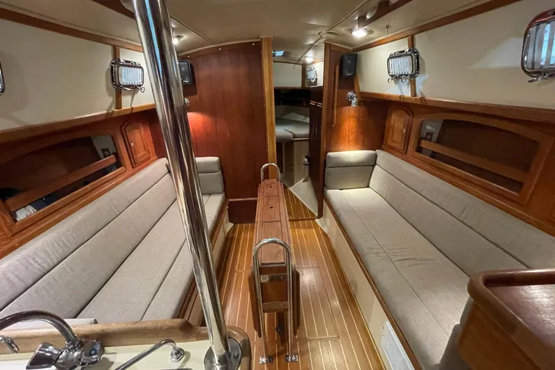 Slide: The Image of Interior of 1997 Pacific Seacraft 34 sailboat with wooden finish and cozy seating. - 25