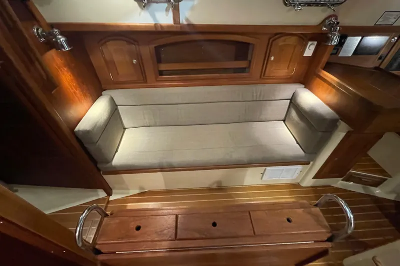 Slide: The Image of Interior of 1997 Pacific Seacraft 34 sailboat with wooden cabinetry and cushioned seating. - 30