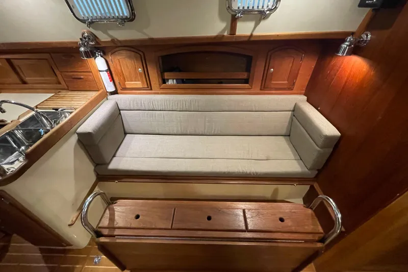 Slide: The Image of Interior of 1997 Pacific Seacraft 34 sailboat with cushioned seating and wooden cabinetry. - 31