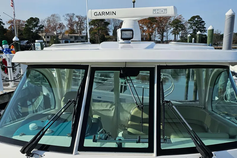 Slide: The Image of 2016 Pursuit OS 385 Offshore boat with Garmin radar, docked at marina. - 10