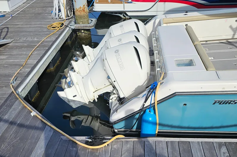 Slide: The Image of 2016 Pursuit OS 385 Offshore boat with dual outboard engines docked. - 4