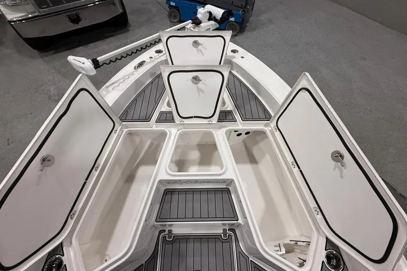 Slide: The Image of 2022 Crevalle 26 HCO boat with open storage compartments and sleek design. - 8