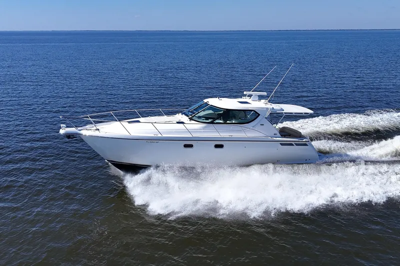 Slide: The Image of 2008 Tiara Yachts 4300 Sovran cruising on open water, showcasing sleek design and performance. - 2