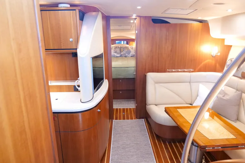 Slide: The Image of 2008 Tiara Yachts 4300 Sovran helm with navigation screens, steering wheel, and ocean view. - 29