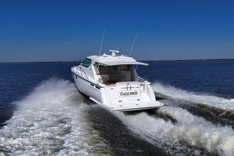 Slide: The Image of 2008 Tiara Yachts 4300 Sovran cruising on open water under clear blue skies. - 3
