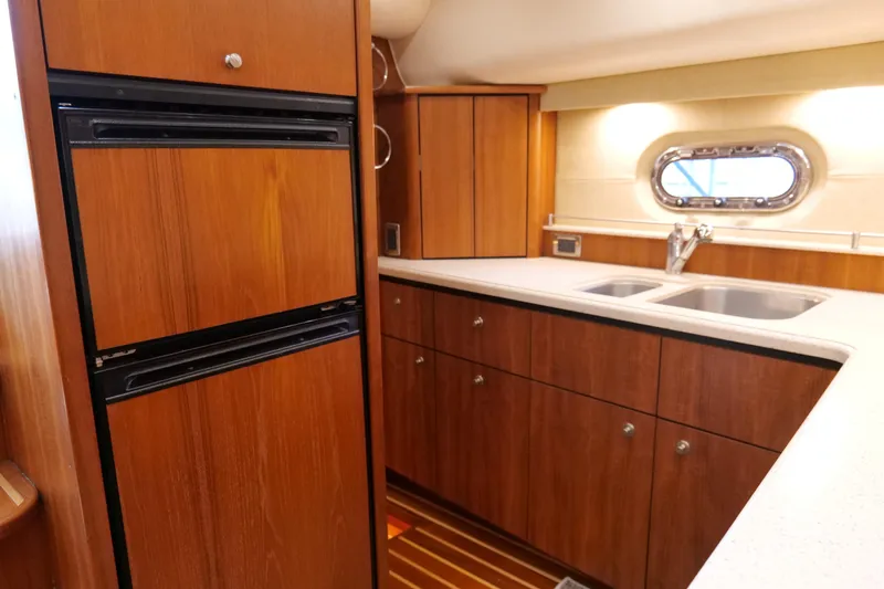 Slide: The Image of Luxurious 2008 Tiara Yachts 4300 Sovran interior with wood cabinetry and flat-screen TV. - 34