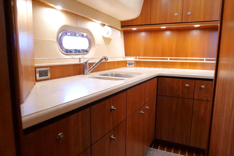 Slide: The Image of 2008 Tiara Yachts 4300 Sovran kitchen with wood cabinetry and dual sinks. - 35