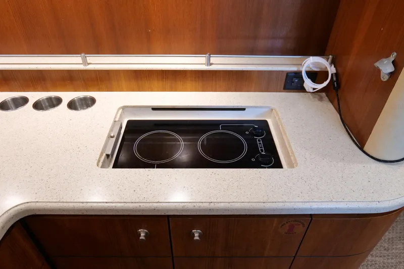 Slide: The Image of Luxurious 2008 Tiara Yachts 4300 Sovran kitchen with wood cabinetry and modern fixtures. - 36