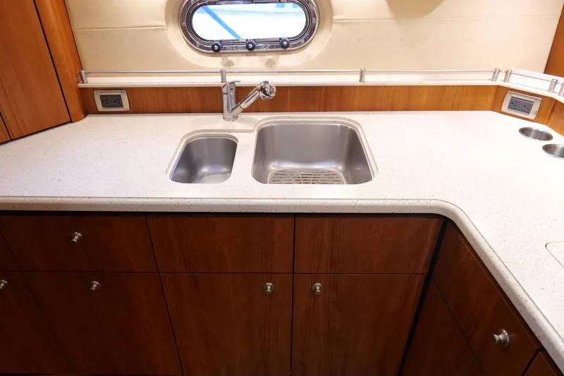 Slide: The Image of 2008 Tiara Yachts 4300 Sovran kitchen with electric stovetop and sleek countertop design. - 37