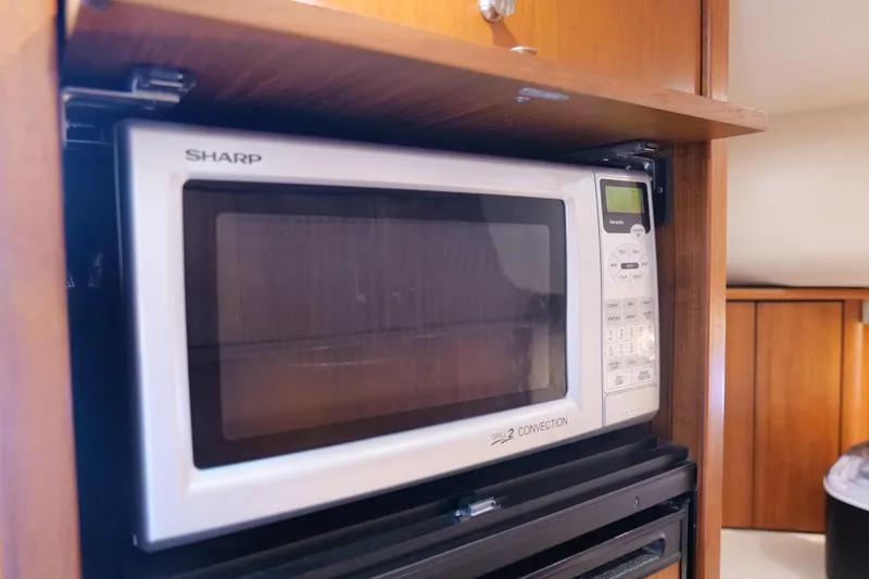 Slide: The Image of 2008 Tiara Yachts 4300 Sovran kitchen with dual sinks and wooden cabinetry. - 38