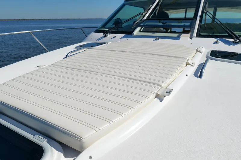 Slide: The Image of 2008 Tiara Yachts 4300 Sovran deck with sunpad, overlooking calm blue waters. - 49