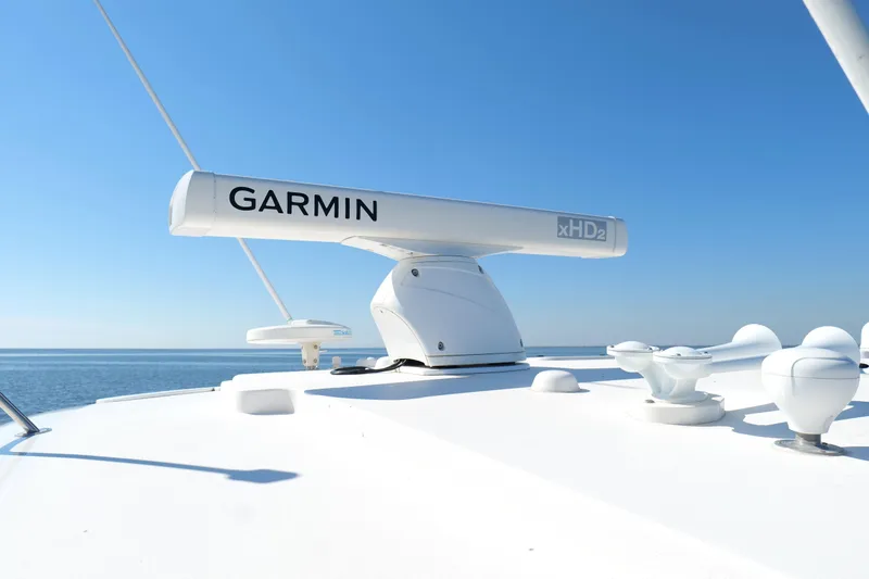 Slide: The Image of 2008 Tiara Yachts 4300 Sovran on calm water, showcasing sleek design and spacious deck. - 51