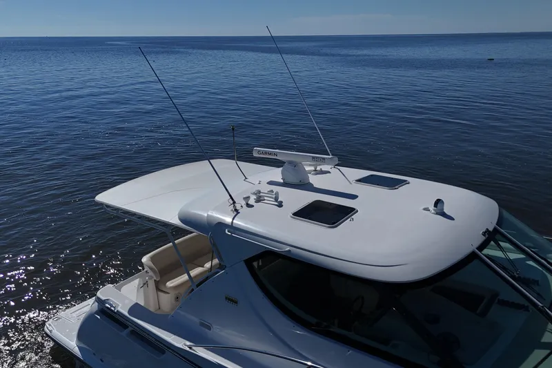 Slide: The Image of 2008 Tiara Yachts 4300 Sovran on calm water, showcasing sleek design and advanced features. - 53