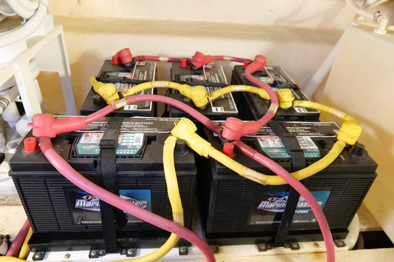 Slide: The Image of Battery setup in a 2008 Tiara Yachts 4300 Sovran, featuring interconnected marine batteries. - 57