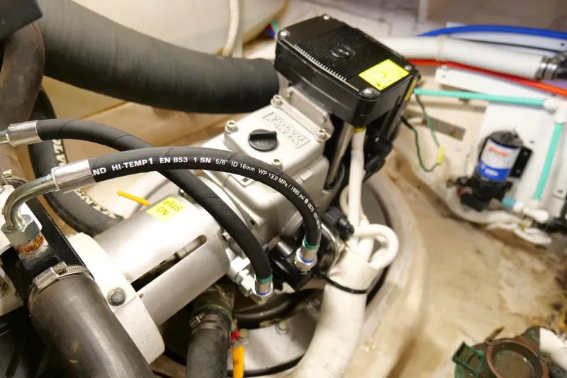 Slide: The Image of Engine compartment of 2008 Tiara Yachts 4300 Sovran, showcasing mechanical components and hoses. - 59