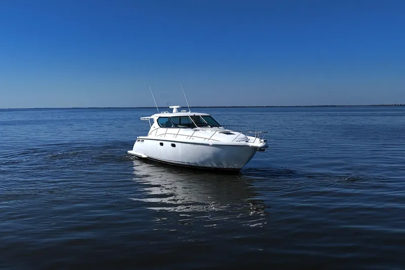 Slide: The Image of 2008 Tiara Yachts 4300 Sovran cruising on calm blue waters. - 6