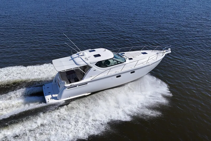 Slide: The Image of 2008 Tiara Yachts 4300 Sovran cruising on open water, showcasing sleek design and performance. - 65