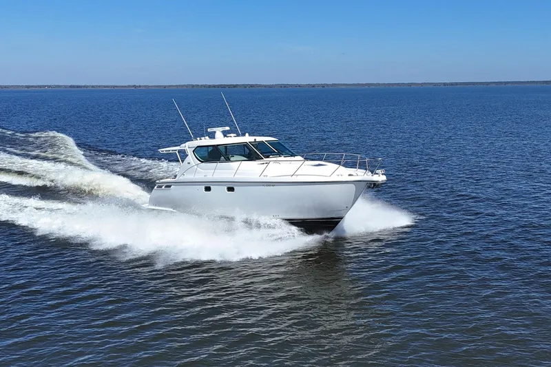 Slide: The Image of 2008 Tiara Yachts 4300 Sovran cruising on open water under clear blue skies. - 66