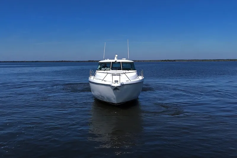 Slide: The Image of 2008 Tiara Yachts 4300 Sovran cruising on calm blue waters. - 7