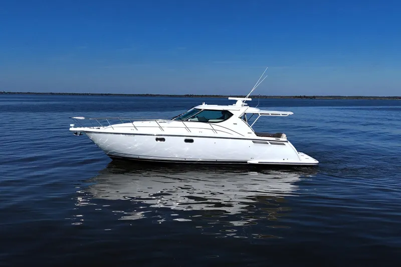 Slide: The Image of 2008 Tiara Yachts 4300 Sovran cruising on calm blue waters under clear skies. - 9