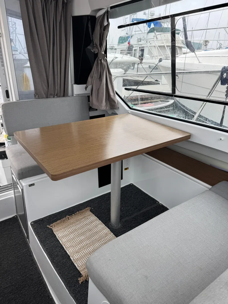 Slide: The Image of Interior seating of 2020 Jeanneau NC 795 boat with gray upholstery. - 14