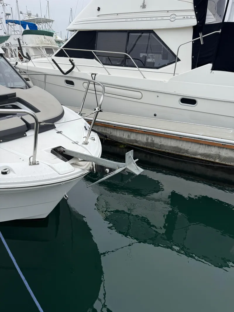 Slide: The Image of 2020 Jeanneau NC 795 boat docked in a marina with Yamaha outboard motor. - 2