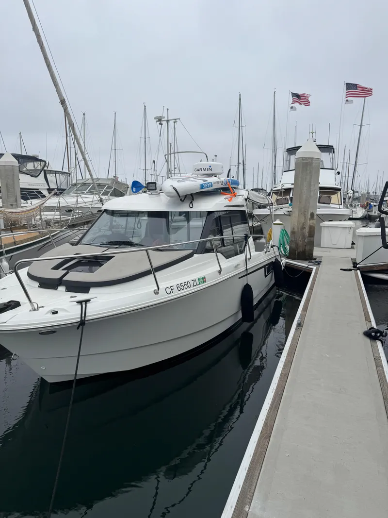 Slide: The Image of 2020 Jeanneau NC 795 boat with cushioned seating at marina. - 20