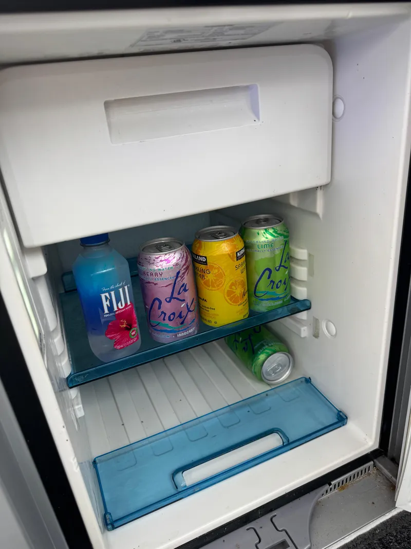 Slide: The Image of 2020 Jeanneau NC 795 boat docked in a marina with calm waters. - 28