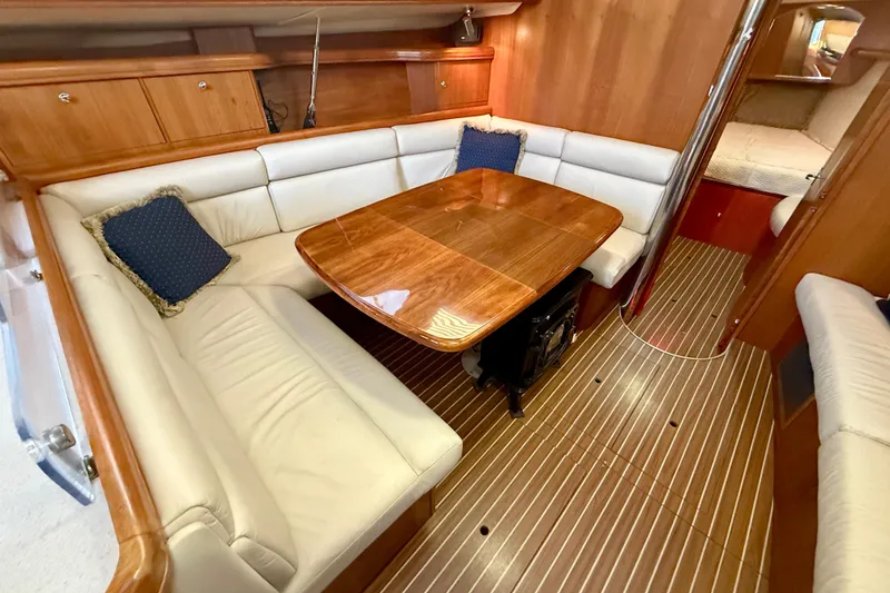 Slide: The Image of Luxurious interior of 2003 Hunter 426 Deck Salon with elegant wood finishes and plush seating. - 10