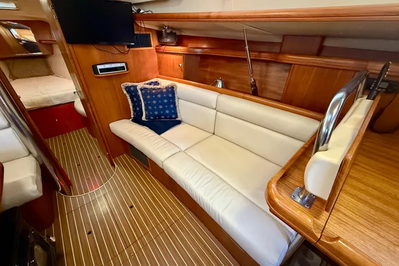 Slide: The Image of Luxurious interior of 2003 Hunter 426 Deck Salon with cozy seating and elegant wood finish. - 11