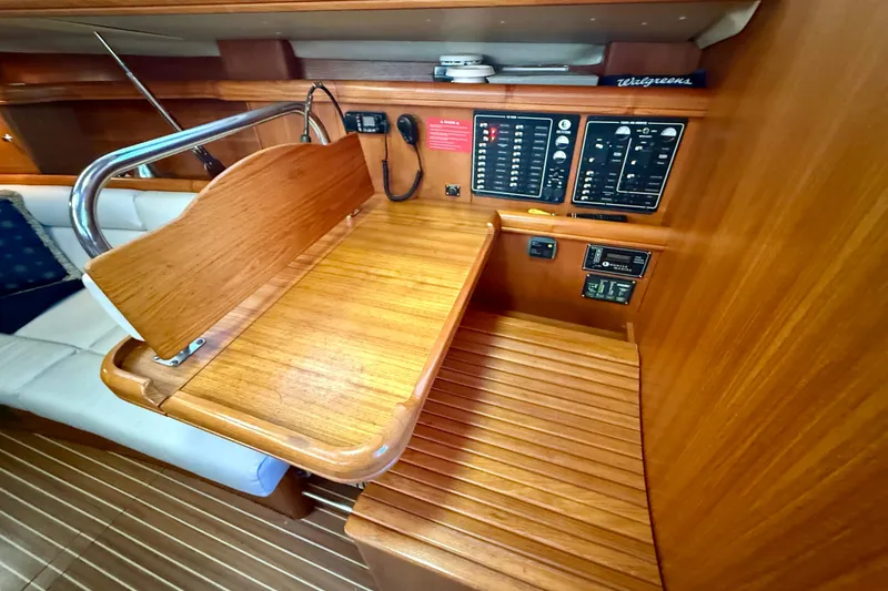 Slide: The Image of Hunter 426 Deck Salon 2003 interior with wooden navigation station and control panels. - 12