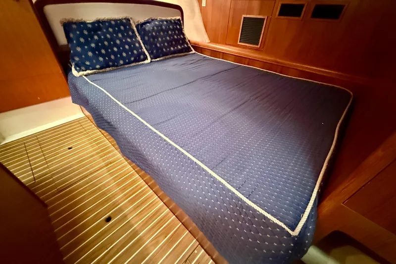 Slide: The Image of Cozy cabin bed in 2003 Hunter 426 Deck Salon yacht with blue bedding. - 13
