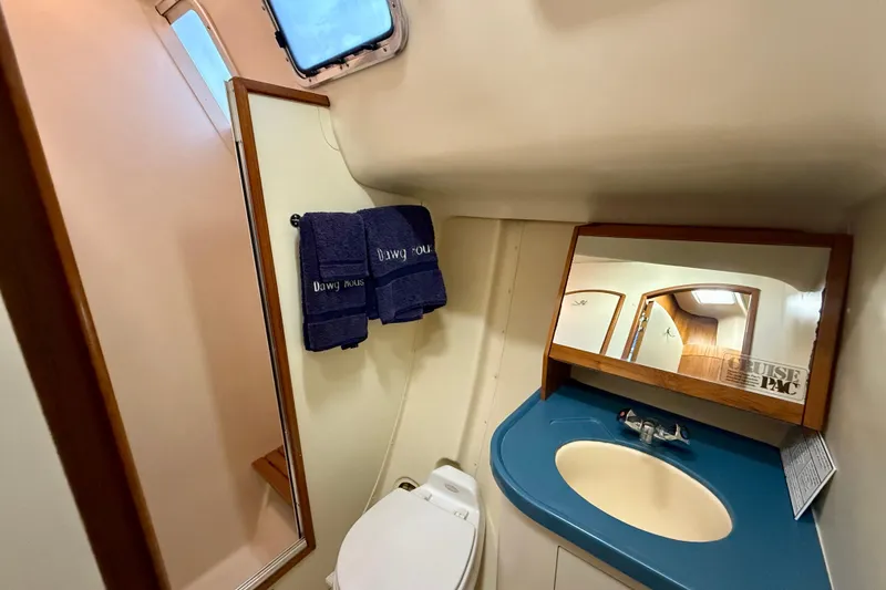 Slide: The Image of Bathroom interior of 2003 Hunter 426 Deck Salon with sink, mirror, and towels. - 17