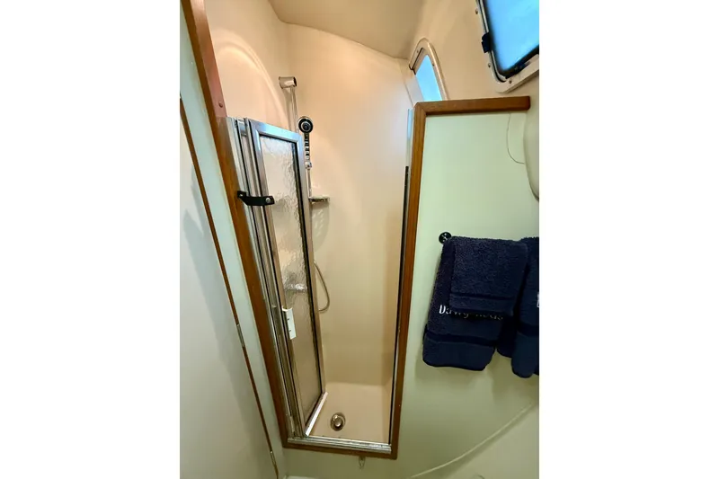 Slide: The Image of Shower area in 2003 Hunter 426 Deck Salon yacht with glass door and towels. - 18