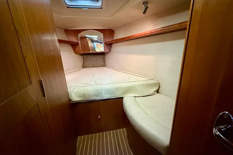 Slide: The Image of Cozy cabin interior of 2003 Hunter 426 Deck Salon yacht with wooden finish and bed. - 21